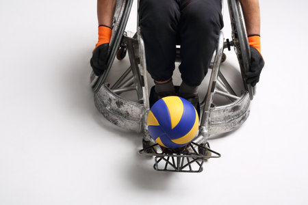 Handball in a wheelchair. The man on the sports wheelchair with the ballの写真素材