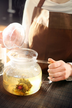Blooming tea brewed in a glass jug.の写真素材