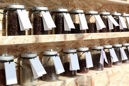 Coffee roaster. Shelf with jars of coffee beansの写真素材