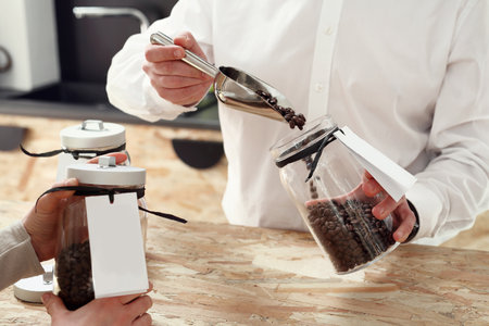 Coffee shop. Seller coffee advises the client of the in-store shoppingの写真素材