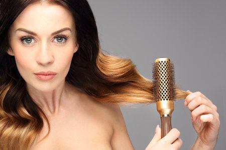 Laying, modeling hair on a round brush.の写真素材