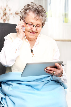 Elderly woman talking on the phoneの写真素材