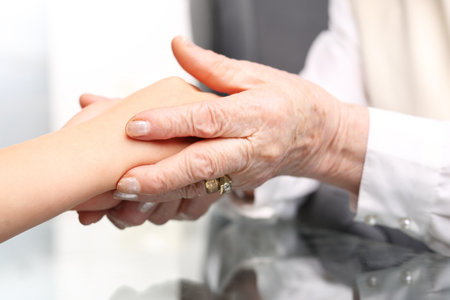 Helping hand. The hand old woman hugs a child's handの写真素材