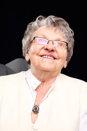Smiling grandmother. Cheerful, smiling old woman sitting in the chairの写真素材