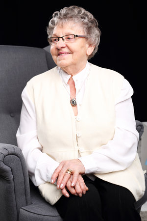 Grandmother. Cheerful, smiling old woman sitting in the chairの写真素材