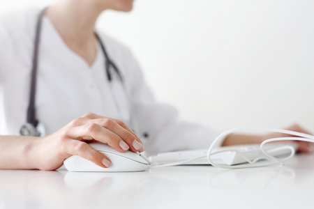 A doctor at the desk using the computerの写真素材