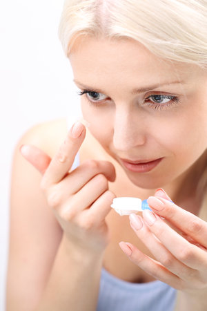 Contact lenses. woman assumes contact lenses.の写真素材
