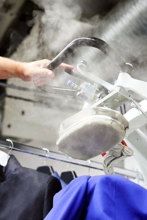 Ironing steam. Presser in sewing clothes pressed.の写真素材
