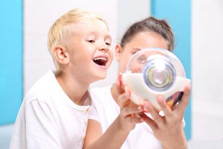 Children's smile. Children watch a model eye in the school laboratory.の写真素材