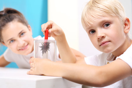 A magnetic field. The child sees the phenomenon of magnetic field on the lessons of physics.の写真素材