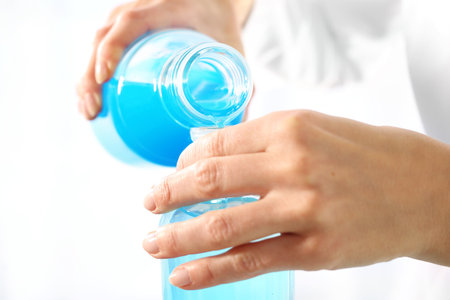 Chemical experience. Chemist poured liquids in glass rulersの写真素材