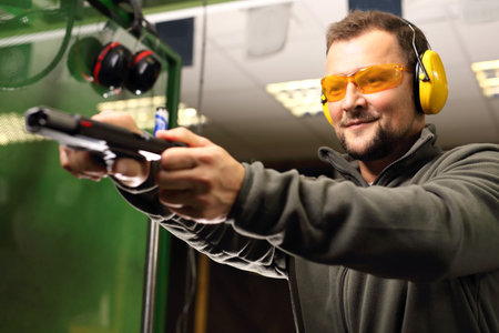 The man at the shooting range. The man at the pistol shooting reloadsの写真素材