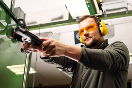 Shooting a gun at shooting rangeの写真素材