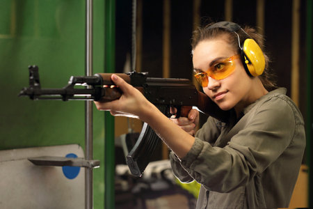 The woman at the shooting range shot from a rifle.の写真素材