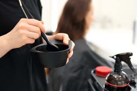 Hair dyeing. Barber hair dye is applied with a brushの写真素材