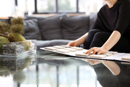Woman chooses carpet for the living roomの写真素材