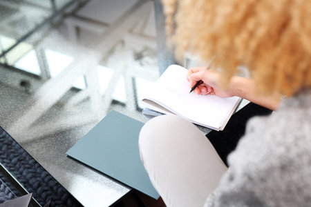 woman writes in a notebook.