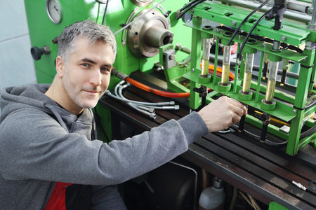 A device for checking the injectors.Car mechanic in the workshop.