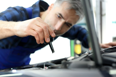 Mechanic tightened the valve steering fluid reservoirの写真素材