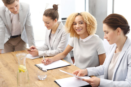 Office work.A group of young workers at a meeting in the company conference roomの写真素材