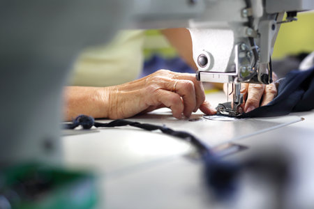 Sewing machine. The production plant, sewing clothes by seamstresses on the sewing machineの写真素材