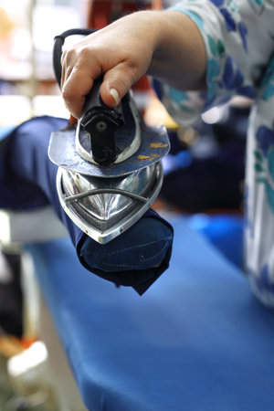 Ironing professional. Presser in sewing clothes pressed.の写真素材