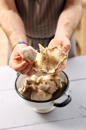 Chef holding oyster hats in hand.の写真素材