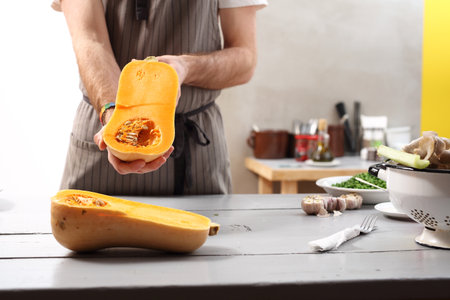 Pumpkin dishes. The cook holds in his hand mature butternut squash.の写真素材