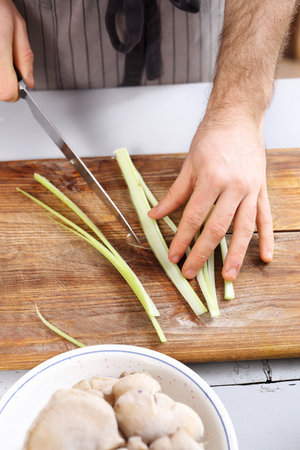 Slicing knife vegetables. Cook chopped vegetables on a chopping board.の写真素材