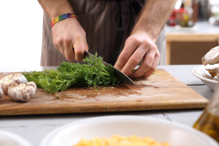 Cook the sliced ??fennel. Hands chef chopping vegetables on worktop