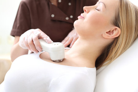 Phototherapy, a woman in the beauty salon. Light acne treatment, the woman in the beauty salonの写真素材