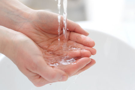 Wash your hand. Woman rinsing her hands under water.の写真素材