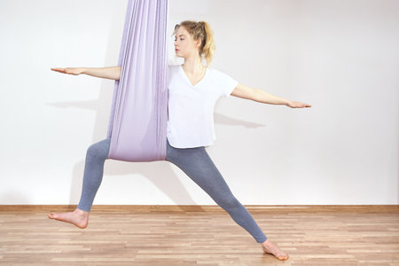 Yoga positions. A woman is practicing yoga on a hose, aerial yogaの写真素材