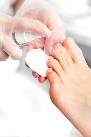 Skin disinfection, beautician disinfects the feet of women with the preparationの写真素材