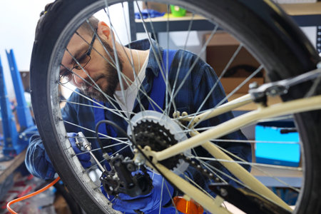 Cleaning your bicycle with compressed air. The bike mechanic in the service cleans the bicycle with compressed air.の写真素材