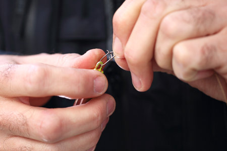 On the fish. Angler holds a bait on his hand.の写真素材
