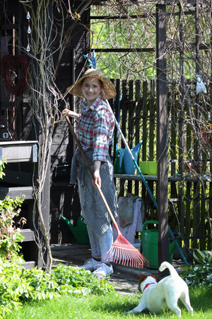 Woman raises lawn. Spring work in home garden.の写真素材