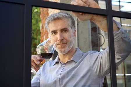Meeting at the restaurant. Man chooses wineの写真素材