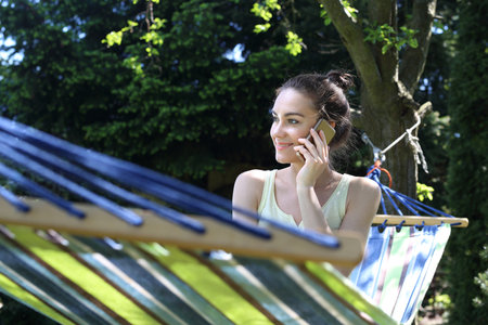 Relax in the sun. Young woman resting on a hammockの写真素材