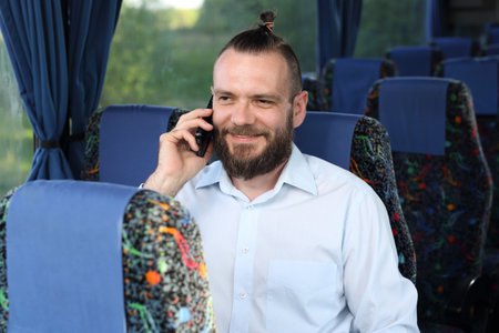People on the bus. Passenger speaks on the phone while traveling.の写真素材