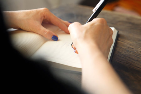 Woman writes a note in the calendar