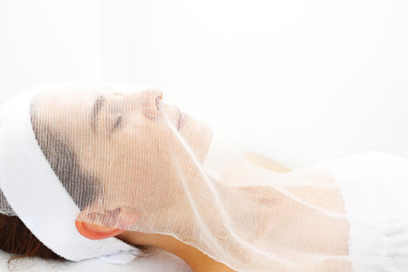 Lifting treatment on the skin of the face. Woman in the beauty salon.の写真素材