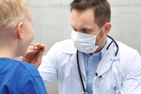 The pediatrician checks the boy's gardの写真素材