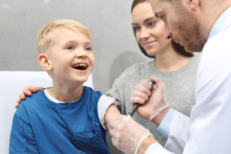 Diabetes in children. Injection with insulin. The doctor gives the child an insulin injection.の写真素材