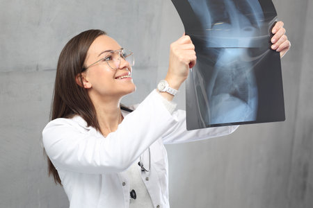 The medical doctor is watching the X-rayの写真素材