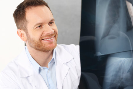 Medical specialist. A doctor in the office is watching an x-ray of a patient.