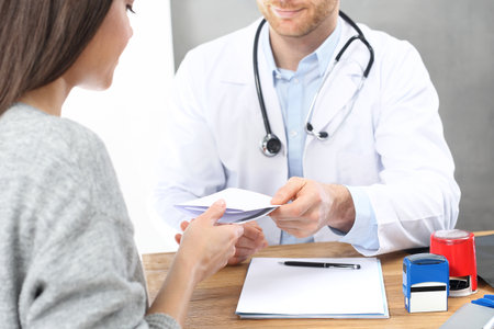 Visit the doctor. The doctor writes a prescription.の写真素材