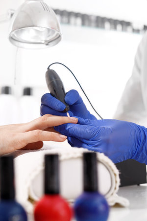 Removing the gel and the hybrid using a cosmetic miller.の写真素材