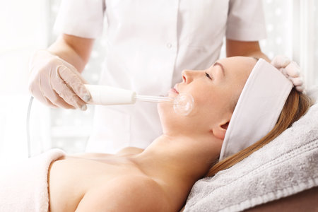 Firming the face skin. Woman in a beauty salonの写真素材