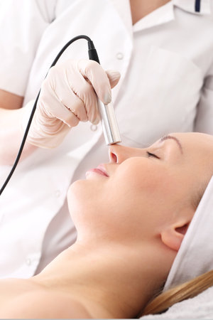 Facial skin care. Woman in a beauty salon. Healthy and well-groomed face skin. Professional...